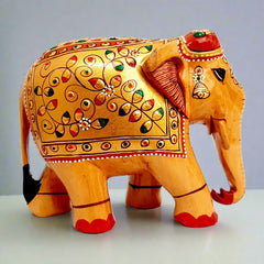 Natural wood elephant statue adorned with embossed floral patterns, handcrafted artisan piece