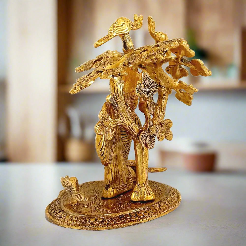 Beautifully crafted metal Radha Krishna idol with two peacocks sitting on a tree, showcasing fine workmanship