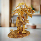 Beautifully crafted metal Radha Krishna idol with two peacocks sitting on a tree, showcasing fine workmanship