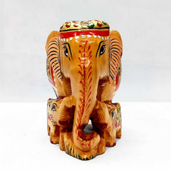 A painted elephant figurine with two babies on both sides, with beautiful paintings on the body.