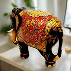 Painted wooden elephant featuring floral emboss design in gold over red background, perfect decorative and gift item