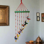 Hand-painted paper mache peacock toran with slant design for wall or door decoration.