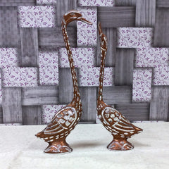 Polished pair of metal swans with copper and silver finish, ideal as a wedding or anniversary gift.