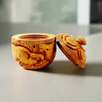 Round hand carved wooden kumkum box for sindoor storage.