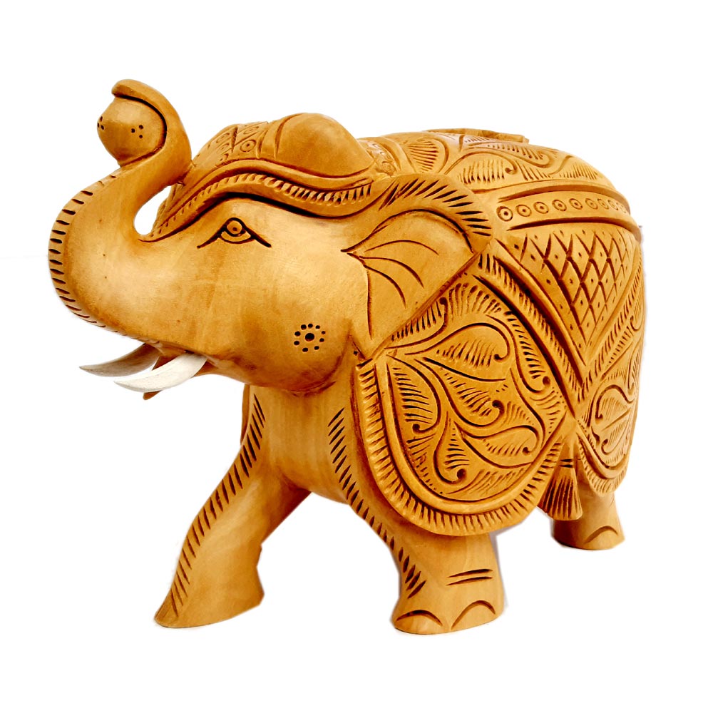 Wooden saluting elephant idol holding a ball in its trunk with white tusks.
