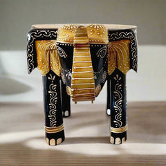 A wooden elephant in a saluting stance, designed as both a stool and a showpiece stand.