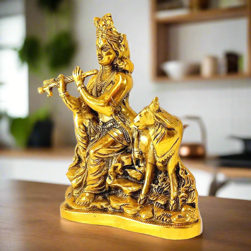 A beautiful sitting Murali Krishna showpiece with a cow's calf, made of metal.