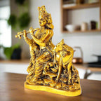 A beautiful sitting Murali Krishna showpiece with a cow's calf, made of metal.
