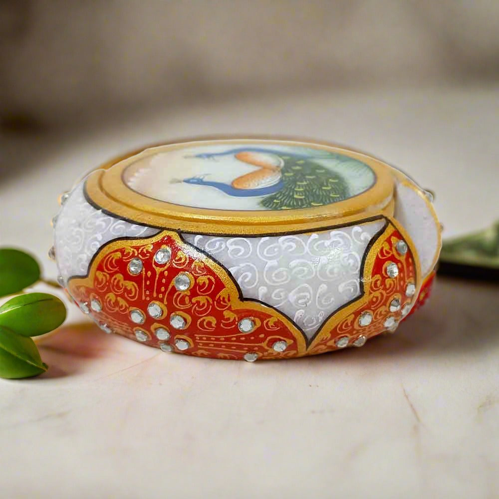 White marble coaster set featuring detailed peacock artwork and emboss-painted holder, ideal for dining or office tables.