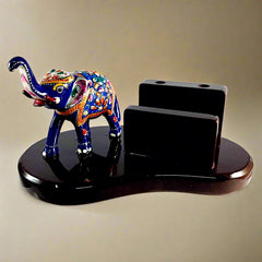 A spectacular wood and metal pen holder with an enamel elephant, a perfect decorative piece.