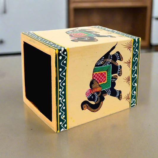 A square-shaped wooden pen stand decorated with miniature elephant figures.