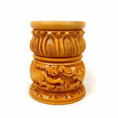 A thick and round-shaped wooden pen stand with detailed animal and lotus carvings.