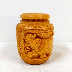 A thick wooden desk organizer with elephant carvings, designed to hold a lot of pens and pencils.