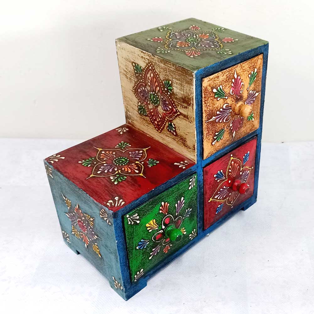 Lifestyle shot of triangular wooden paint box storing small items like earrings and watches