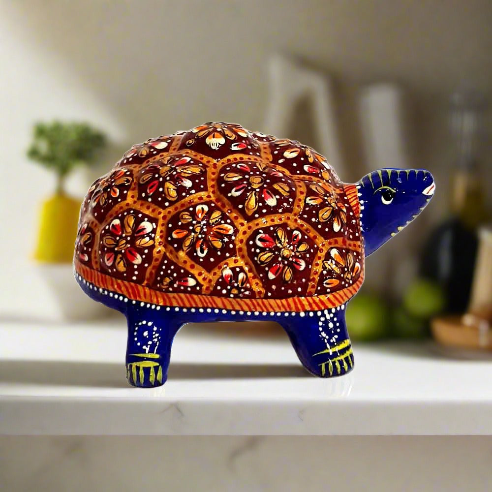 Meenakari tortoise positioned in office pooja room per Vastu principles.