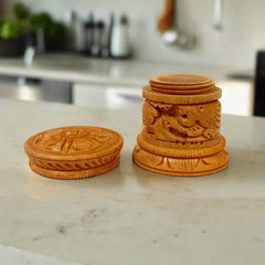 Traditional Dani wood Sindoor box with intricate carving, used for storing vermilion in Indian rituals.