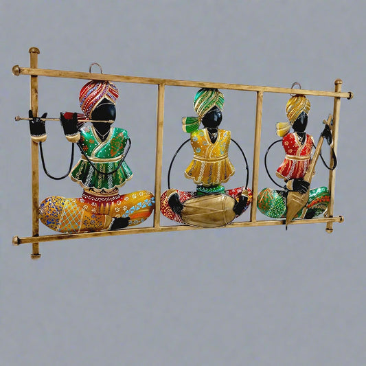 Traditional Rajasthani metal wall art showing magician musicians playing instruments, decorated with vibrant hand painting.