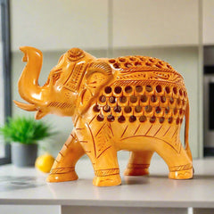 A beautifully carved and undercut elephant, a unique piece for table decor.