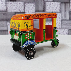 Vintage style wooden auto rickshaw showpiece with traditional hand painting, a nostalgic decor piece.