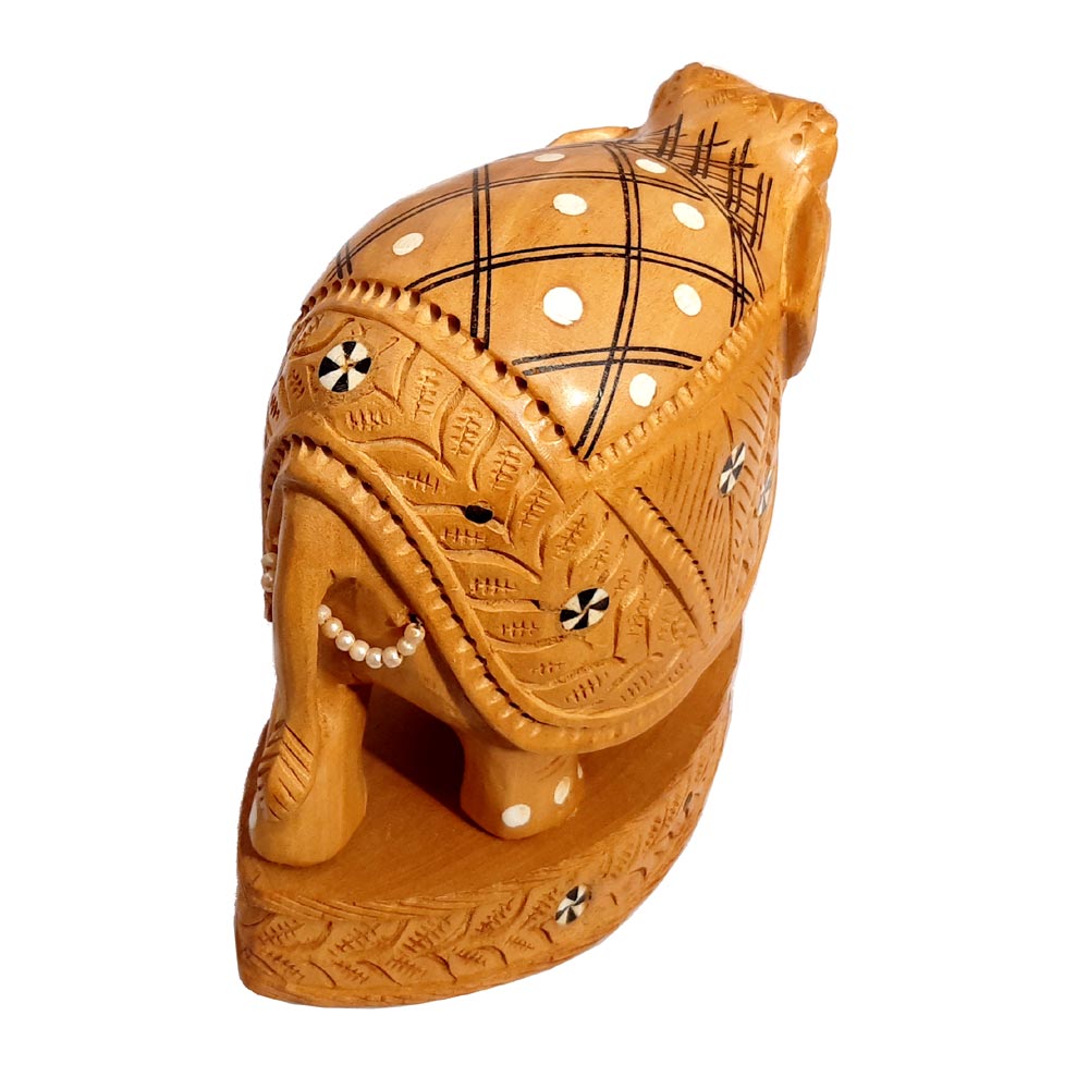 Back showing detailed carvings and inlay patterns on elephant statue.