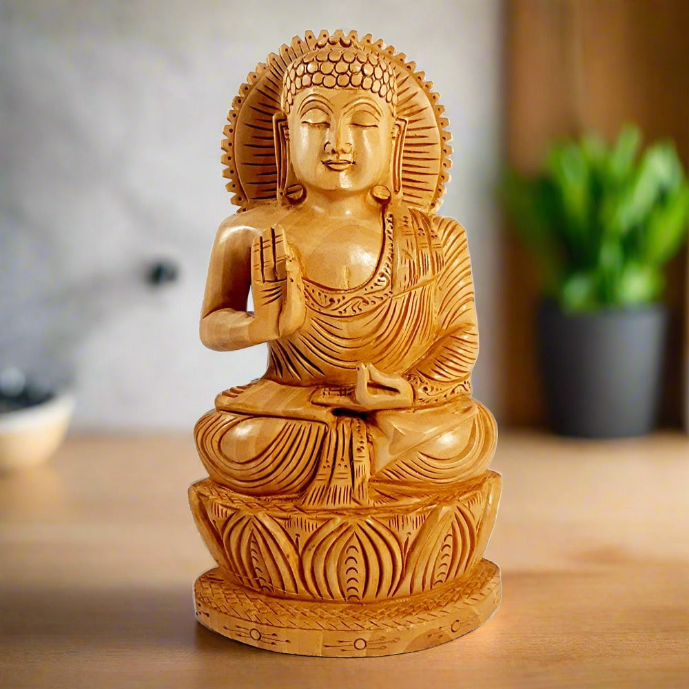 A wooden Buddha idol in a meditative posture, seated on a carved lotus.