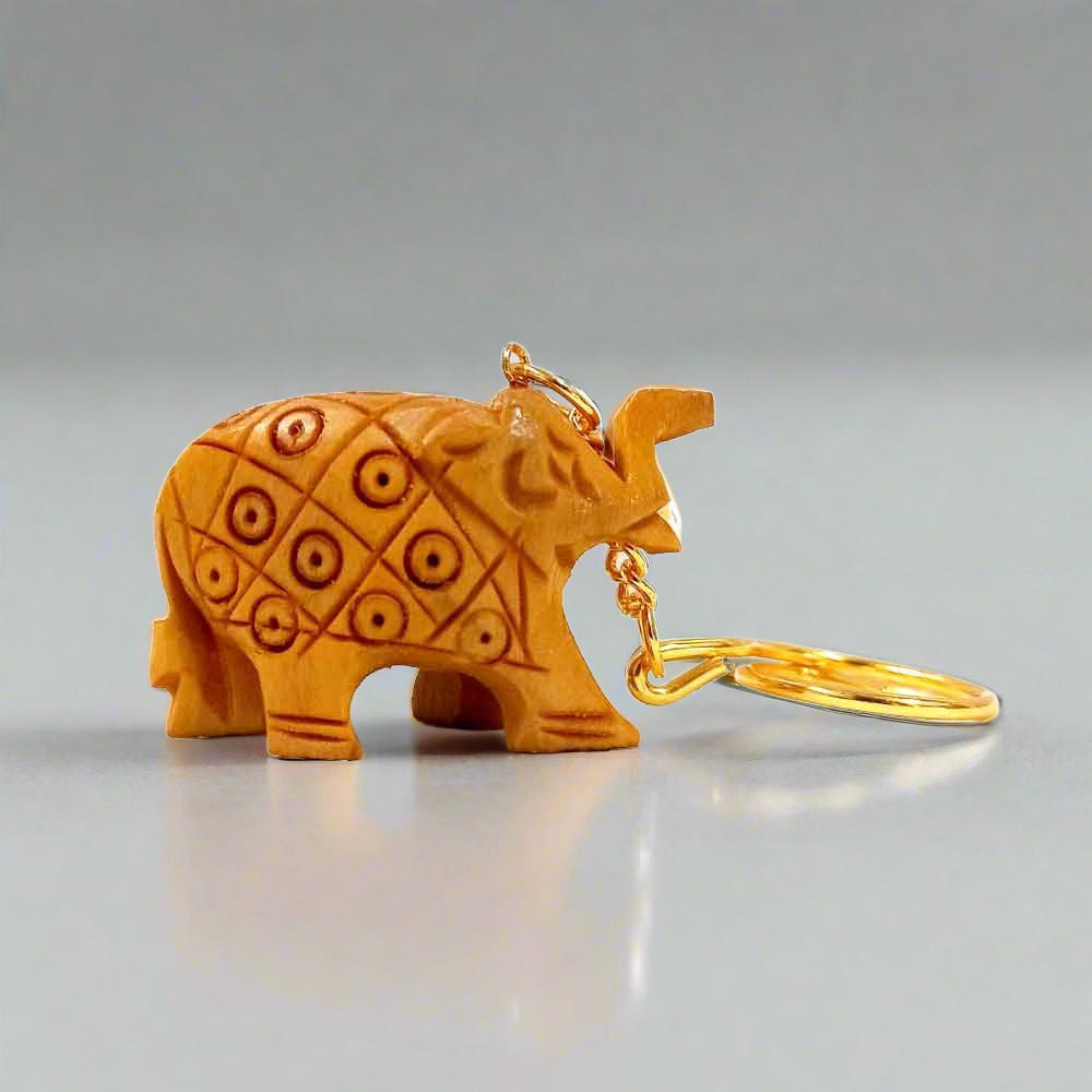 A beautiful wooden carved elephant key chain with a good quality golden ring, perfect for car and bike keys.
