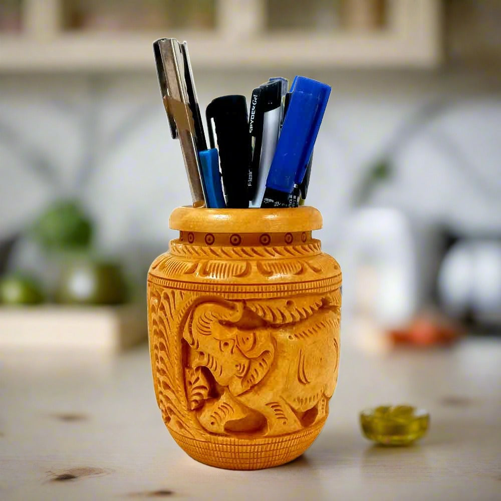 A beautiful wooden pen holder with two carved elephants, made in its natural color.