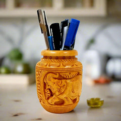 A beautiful wooden pen holder with two carved elephants, made in its natural color.