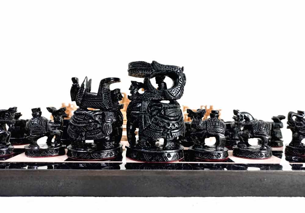 A complete set of wooden chess pieces in the Ambabadi style, along with a 15-inch playing board.