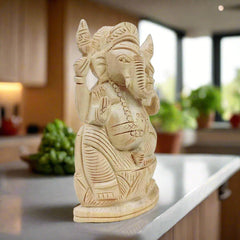 A wooden Ganpati murti used for worship, bringing peace and prosperity.