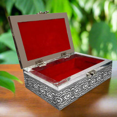 Open interior of silver oxidized jewelry box revealing luxurious red velvet lining