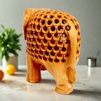 Side view of lucky trunk-up wooden elephant showpiece with intricate wood lattice patterns.