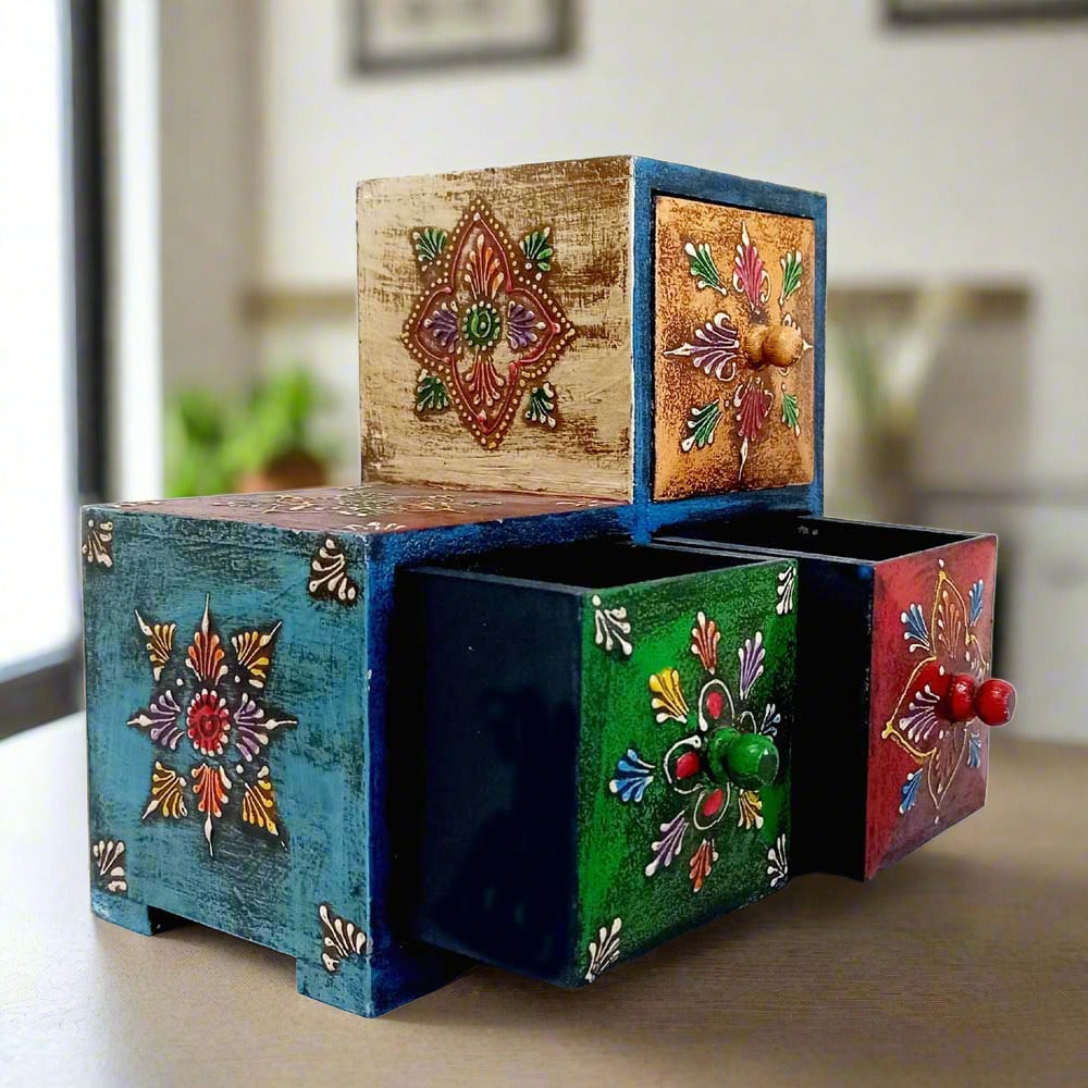 Interior view of wooden paint box showing three drawers for jewelry, earphones, and wristwatches