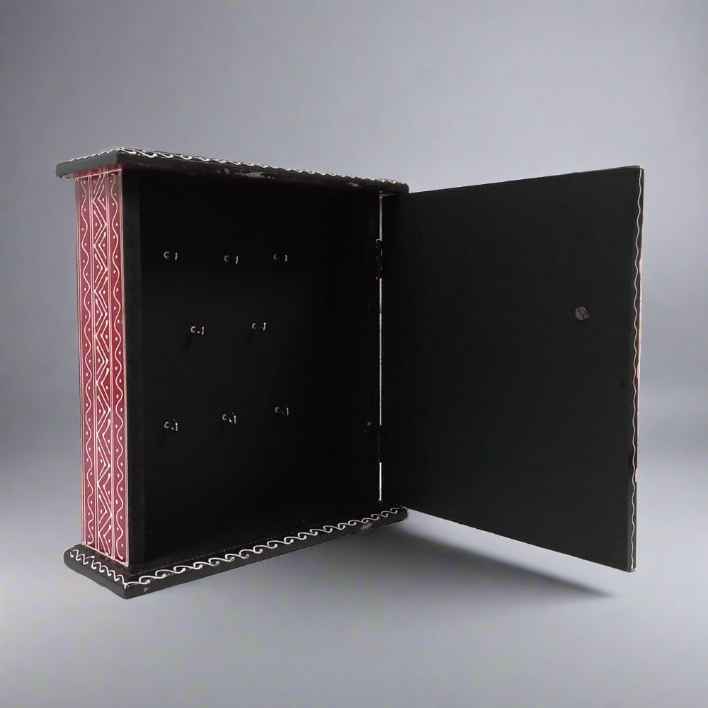 Wooden wall-mounted key holder box featuring intricate hand-painted designs, combining functionality and aesthetics.